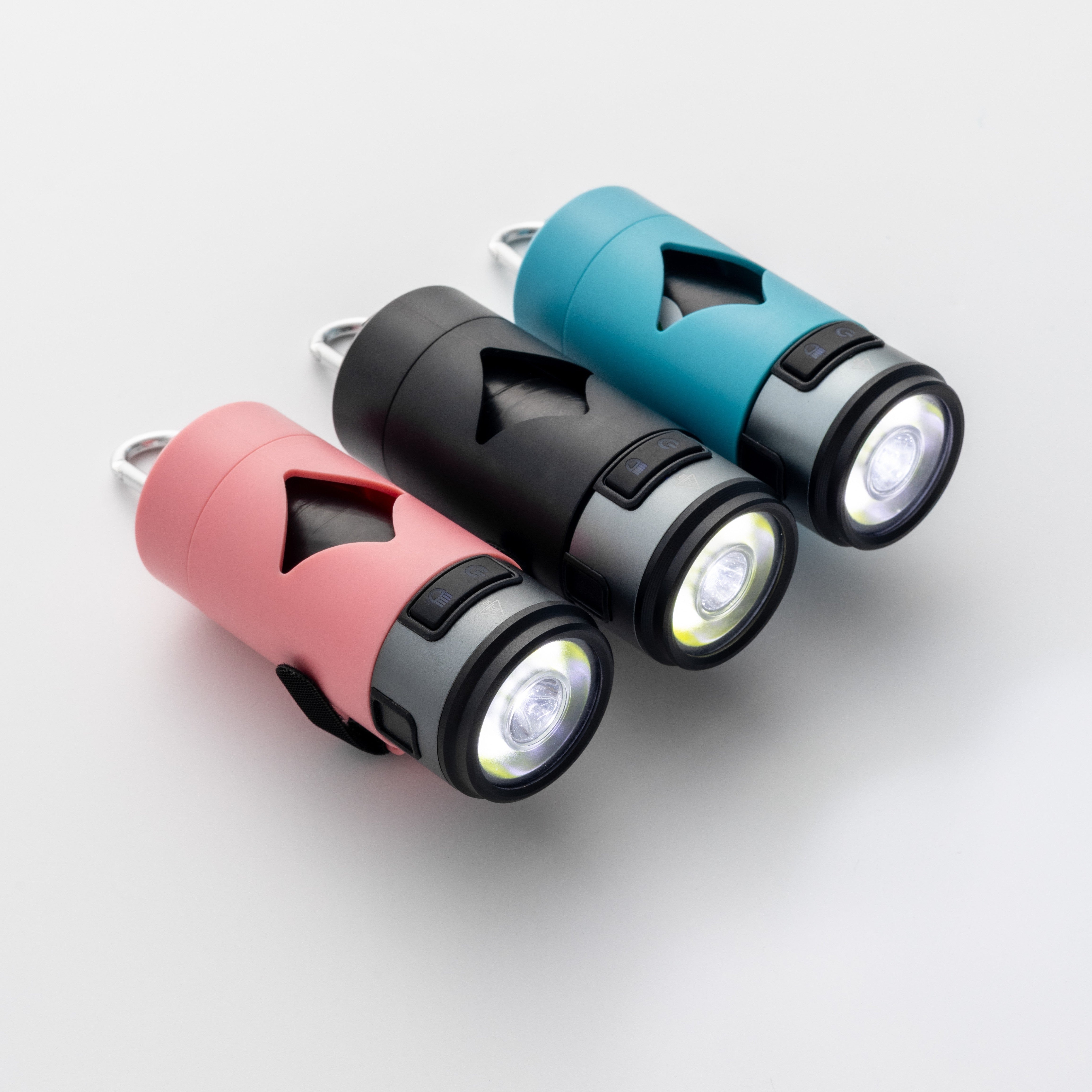 Three illuminated waste bag holders in pink, black, and blue on a white background