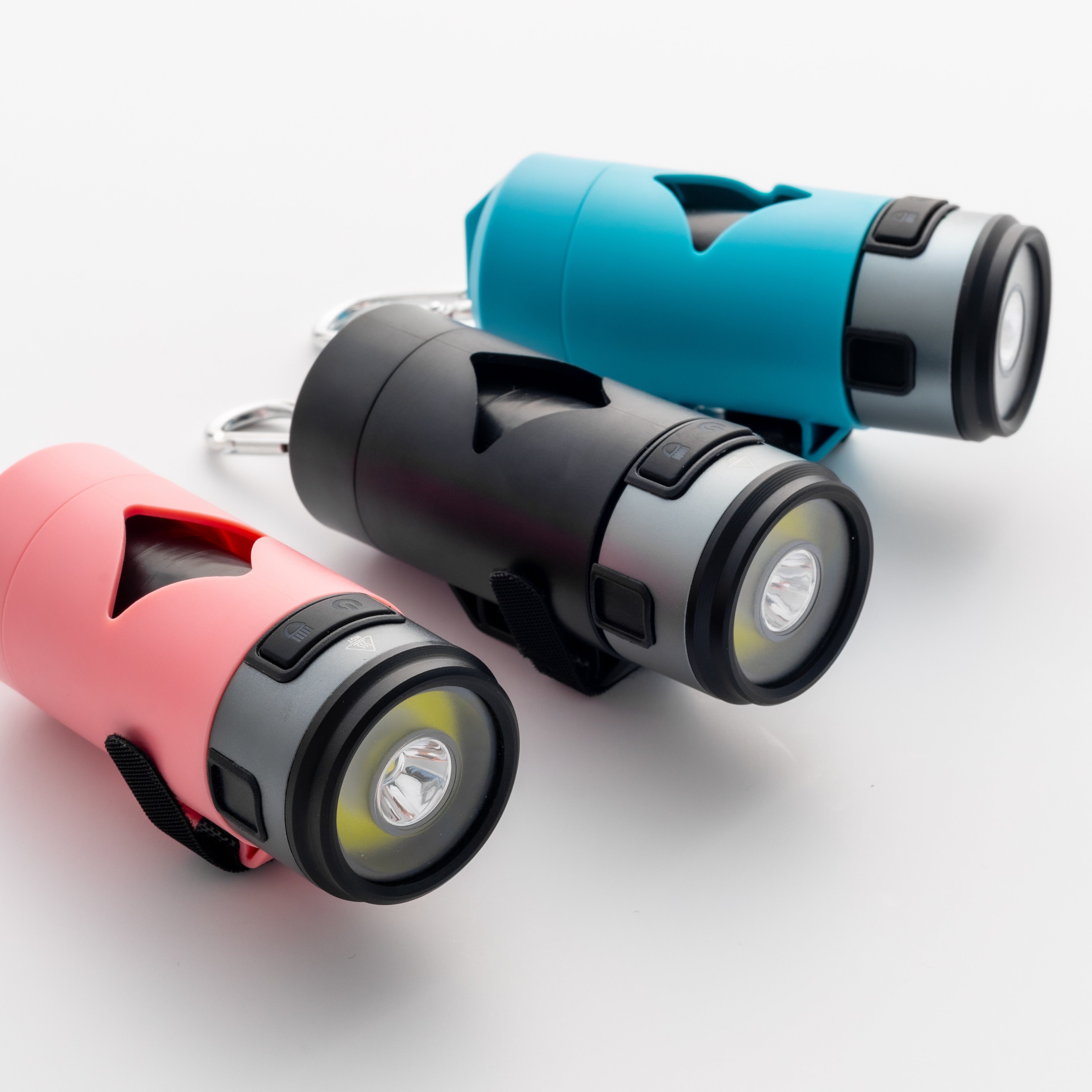 Three colorful LED dog waste bag holders in red, black, and blue on a white background